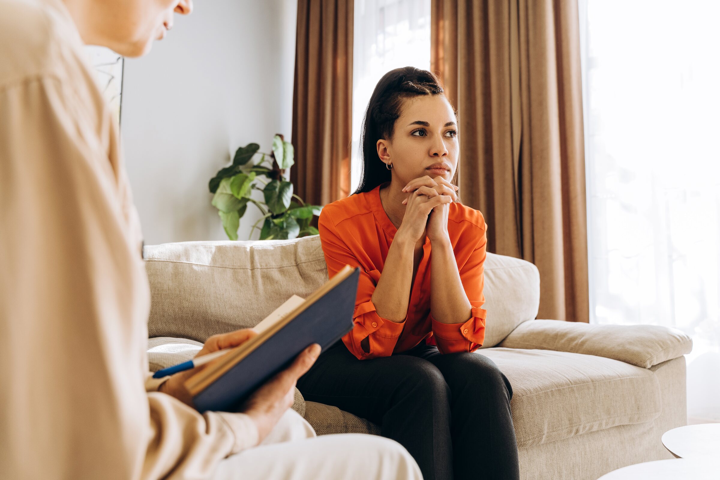 A woman listens closely during a one-on-one therapy session